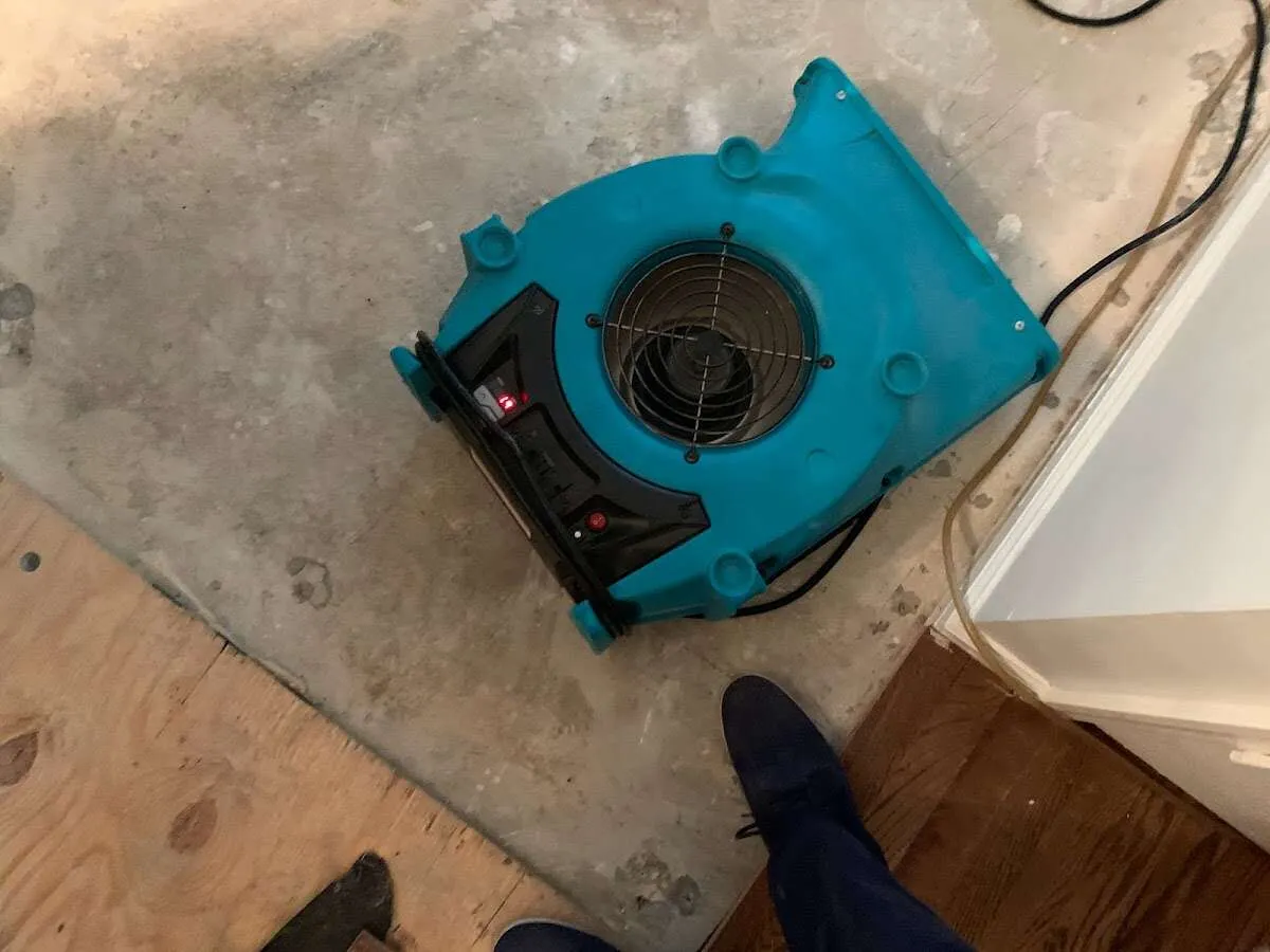 Air mover drying subfloor during Commercial Water Damage Restoration in Hartford City